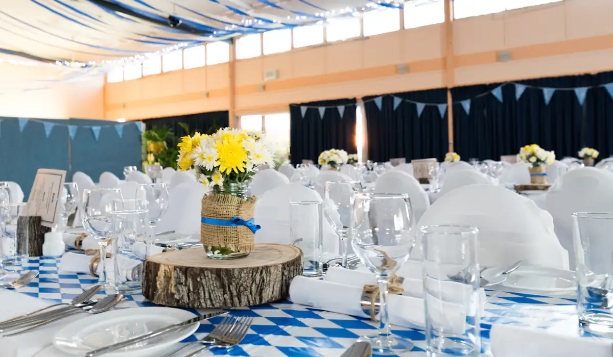 Mesas de casamento com toalhas brancas e arranjos de flores